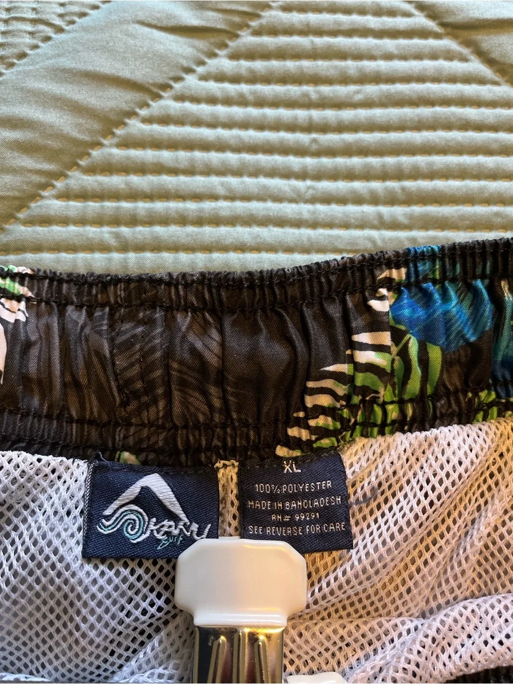 Pair of Kanu Surf Men's Blue Camo & Black Floral Swim Trunks